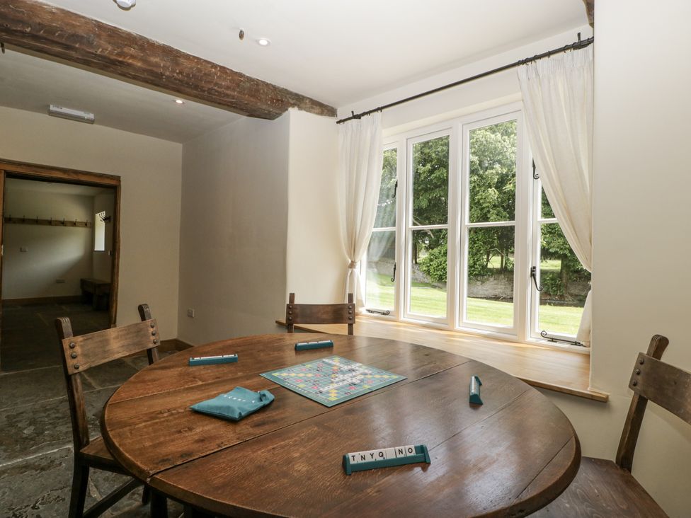 A dining room with a table and chairs at Evenjobb Court Farmhouse Evenjobb near Presteigne