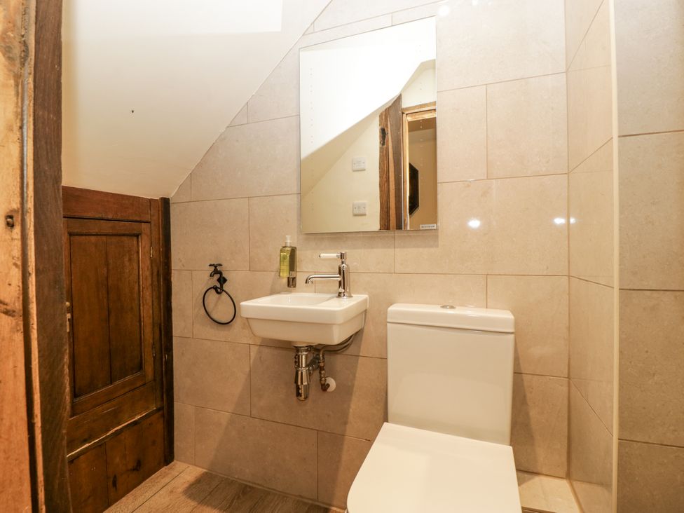 A bathroom with a toilet and sink at Evenjobb Court Farmhouse Evenjobb near Presteigne