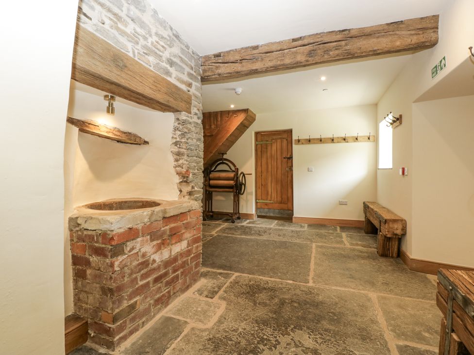 An entrance hall with a washbasin and staircase at Evenjobb Court Farmhouse Evenjobb near Presteigne