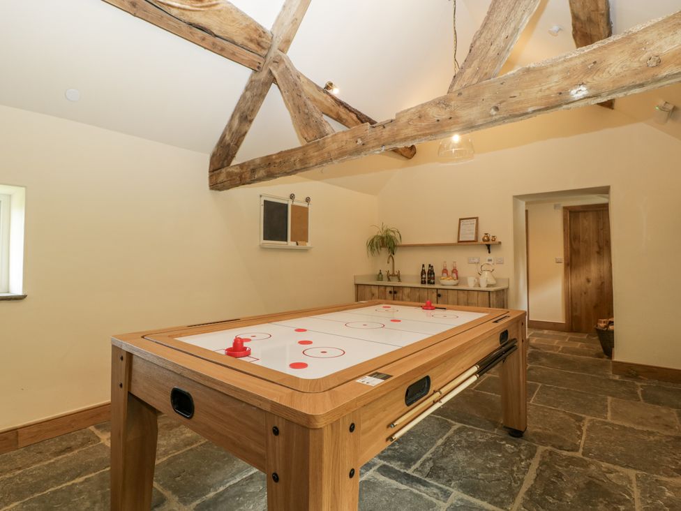 A game room with a pool table and shelves at Evenjobb Court Farmhouse in Evenjobb near Presteigne
