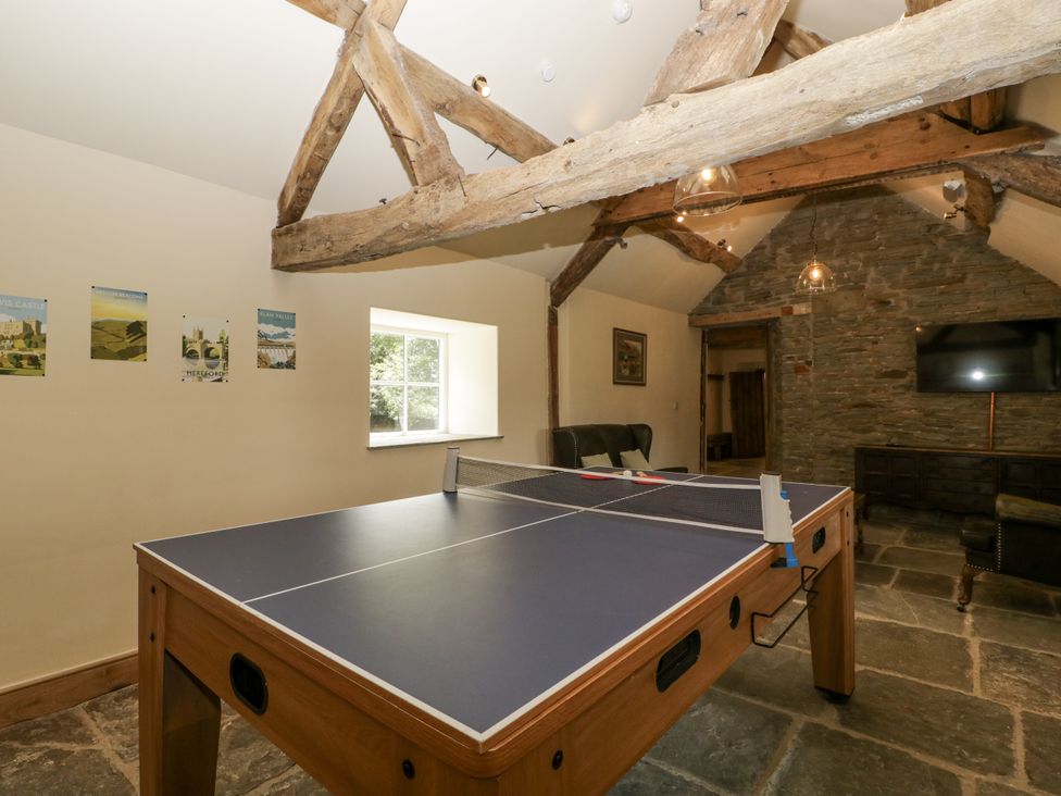 A recreational room with a table tennis table at Evenjobb Court Farmhouse in Evenjobb near Presteigne