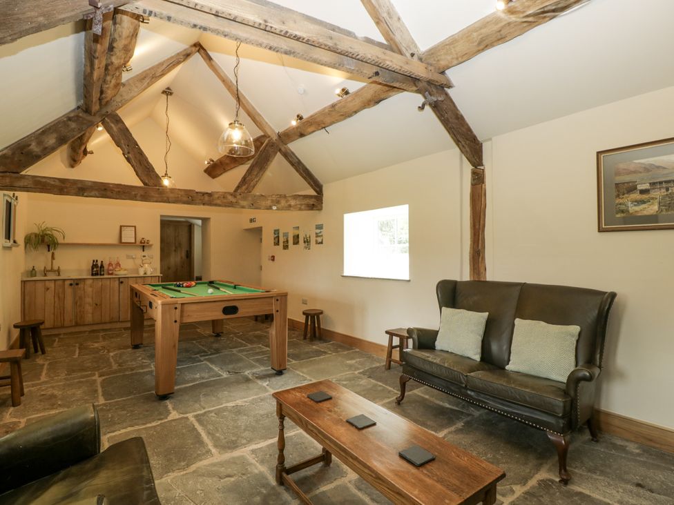 A snug with a pool table and seating area at Evenjobb Court Farmhouse near Presteigne