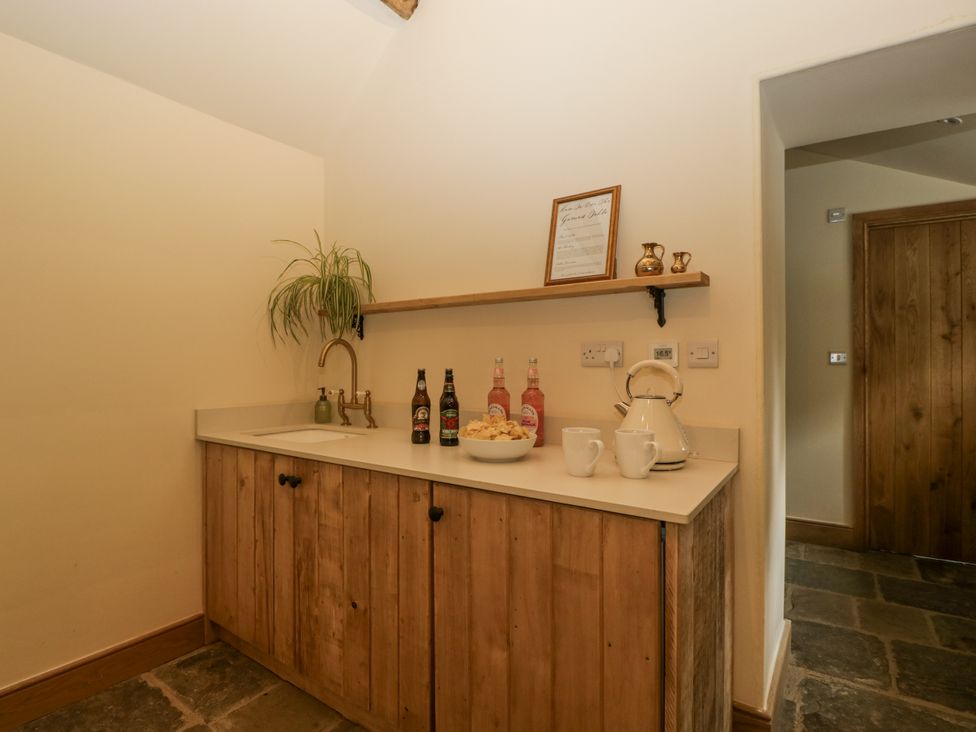 A kitchen space with a sink and a countertop at Evenjobb Court Farmhouse in Evenjobb near Presteigne