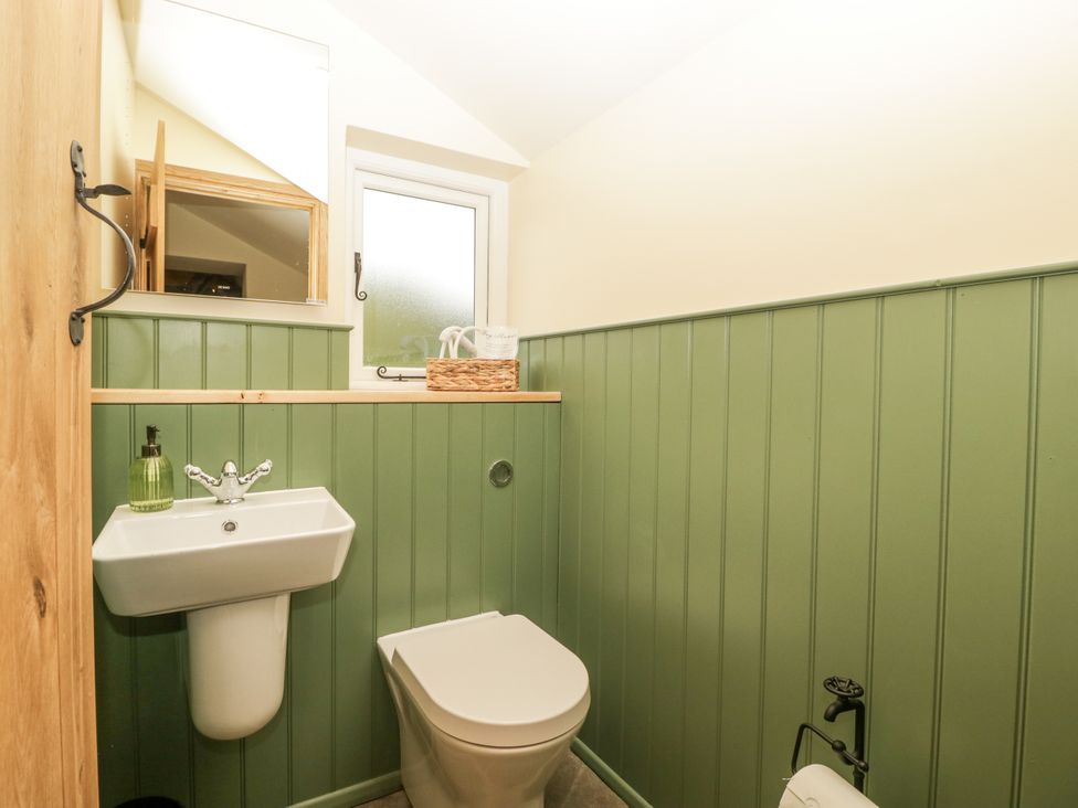 A bathroom with a sink and toilet at Evenjobb Court Farmhouse near Presteigne
