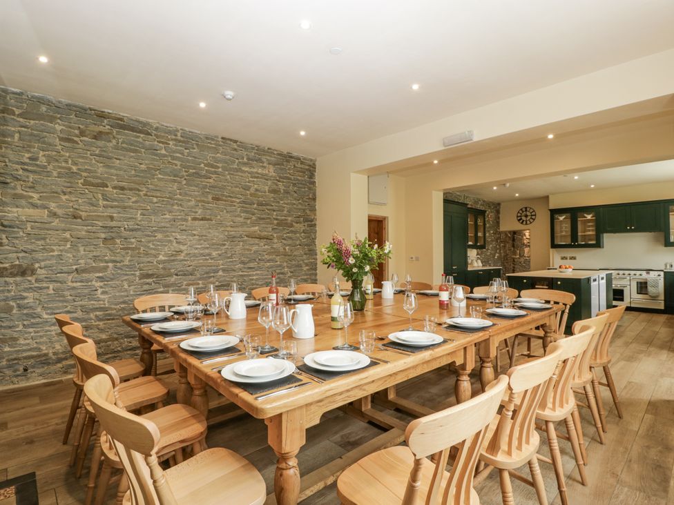 A dining room with a large table and chairs at Evenjobb Court Farmhouse Evenjobb near Presteigne