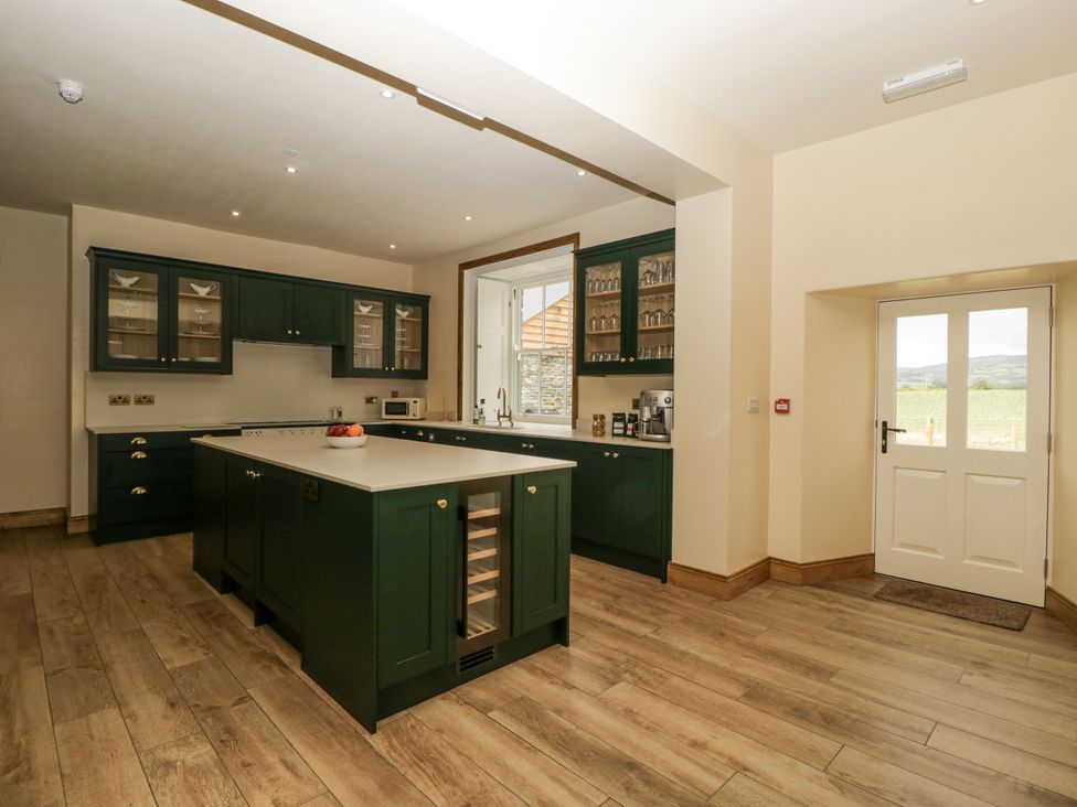 A kitchen with cabinets and a countertop at Evenjobb Court Farmhouse Evenjobb near Presteigne