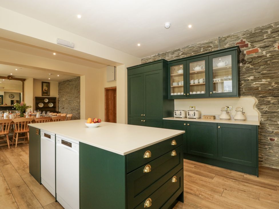 A kitchen with a large island and cabinets at Evenjobb Court Farmhouse Evenjobb near Presteigne