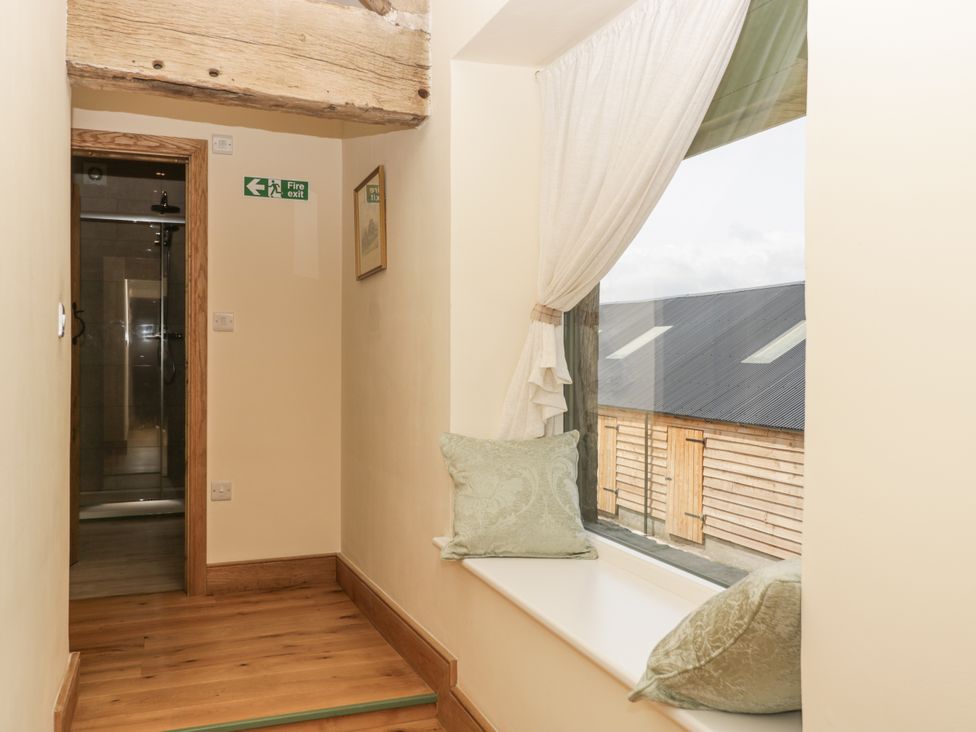 A hallway with a window and cushions at Evenjobb Court Farmhouse in Evenjobb near Presteigne
