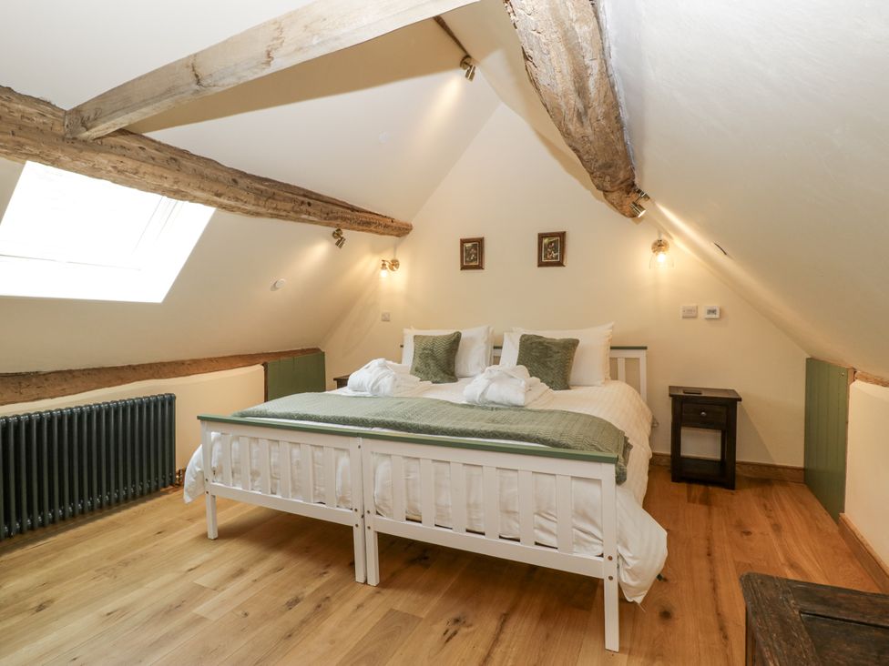 A bedroom with a bed and radiator at Evenjobb Court Farmhouse Evenjobb near Presteigne