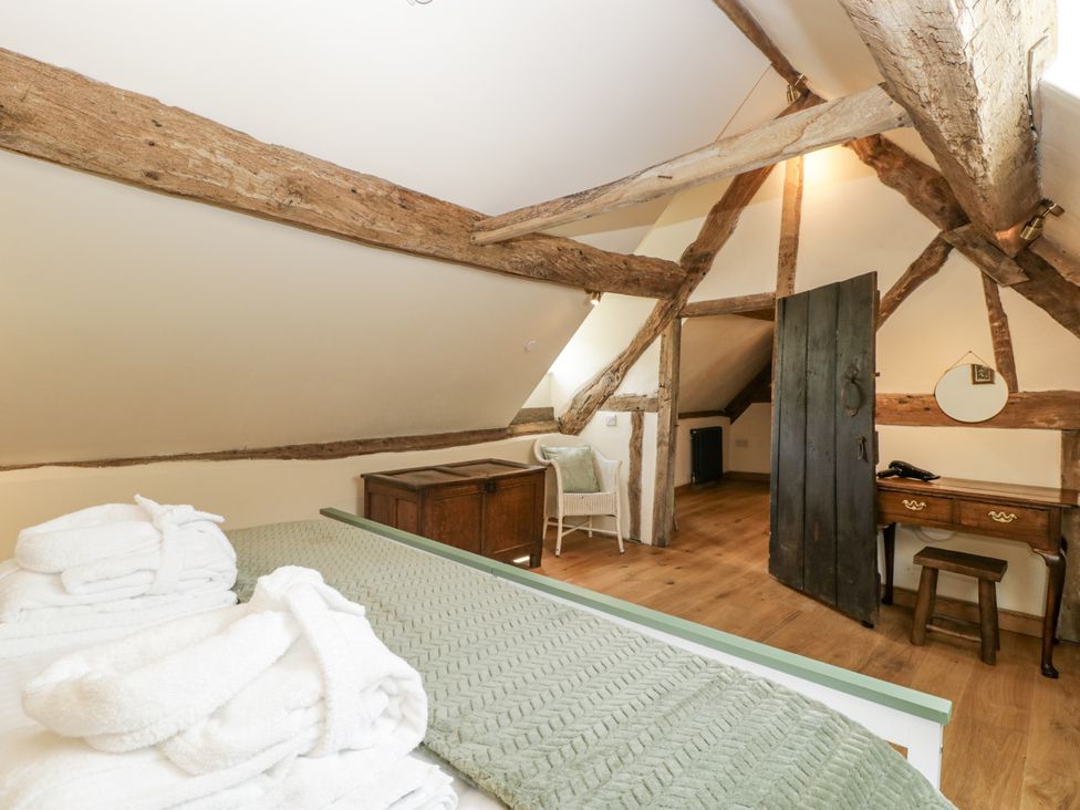A bedroom with a bed and wooden beams at Evenjobb Court Farmhouse Evenjobb near Presteigne