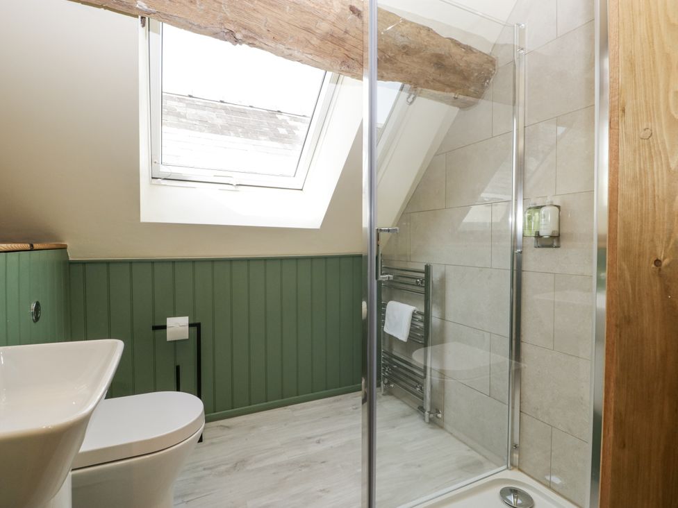 A bathroom with a shower, toilet, and sink at Evenjobb Court Farmhouse in Evenjobb near Presteigne