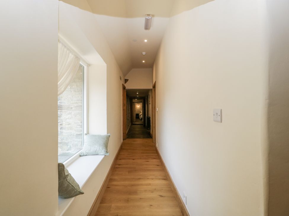 A hallway with a window and cushions at Evenjobb Court Farmhouse near Presteigne