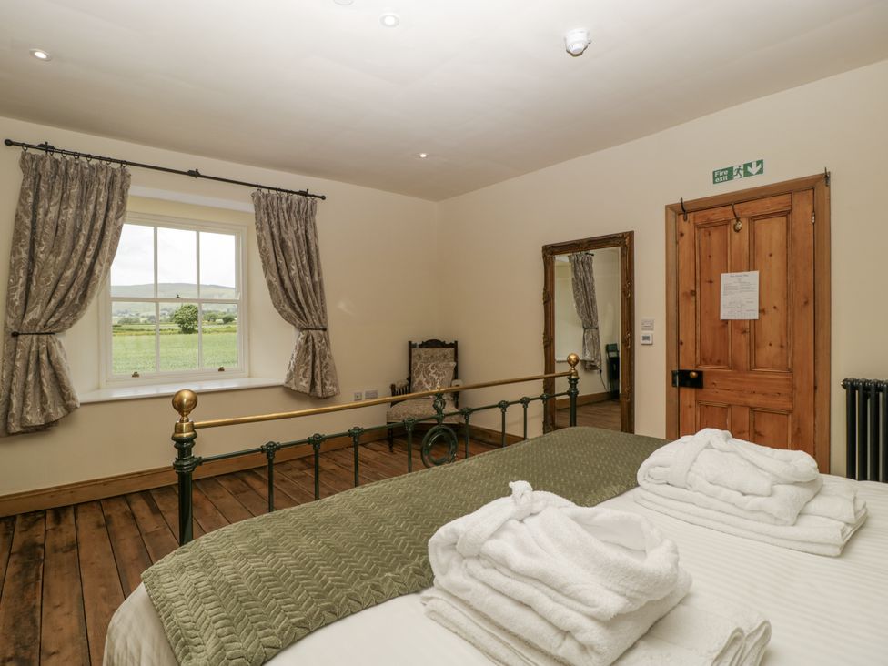 A bedroom with a bed and towels at Evenjobb Court Farmhouse in Evenjobb near Presteigne