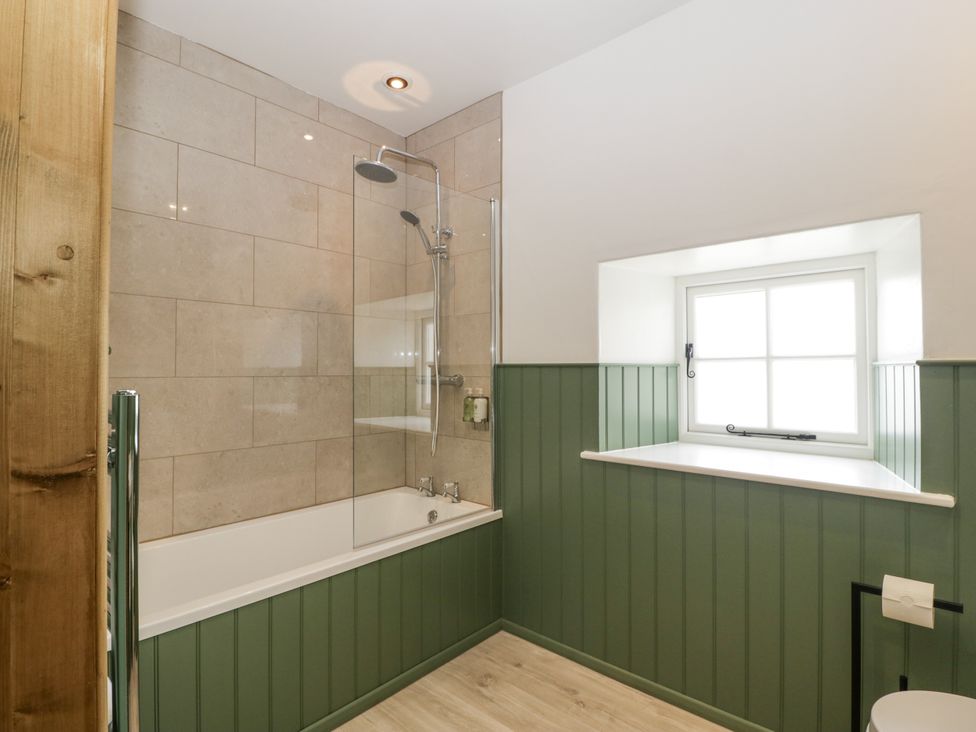 A bathroom with a shower and bathtub at Evenjobb Court Farmhouse Evenjobb near Presteigne