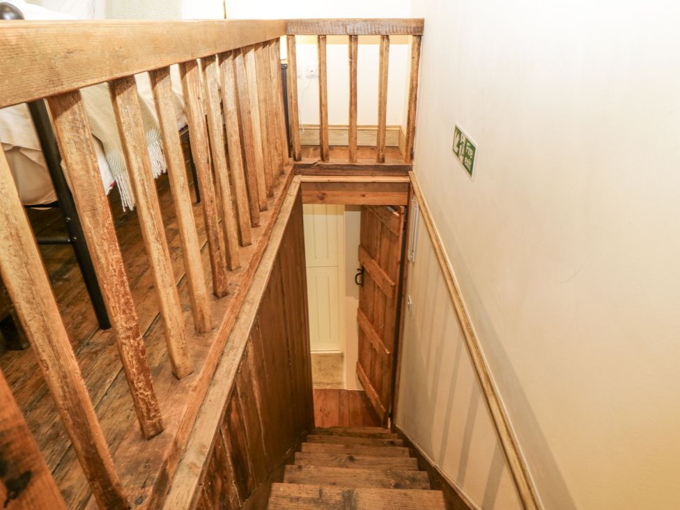 A staircase leading to a door at Evenjobb Court Farmhouse Evenjobb near Presteigne
