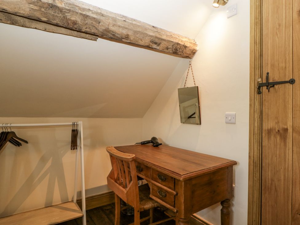 A study area with a desk and chair at Evenjobb Court Farmhouse Evenjobb near Presteigne
