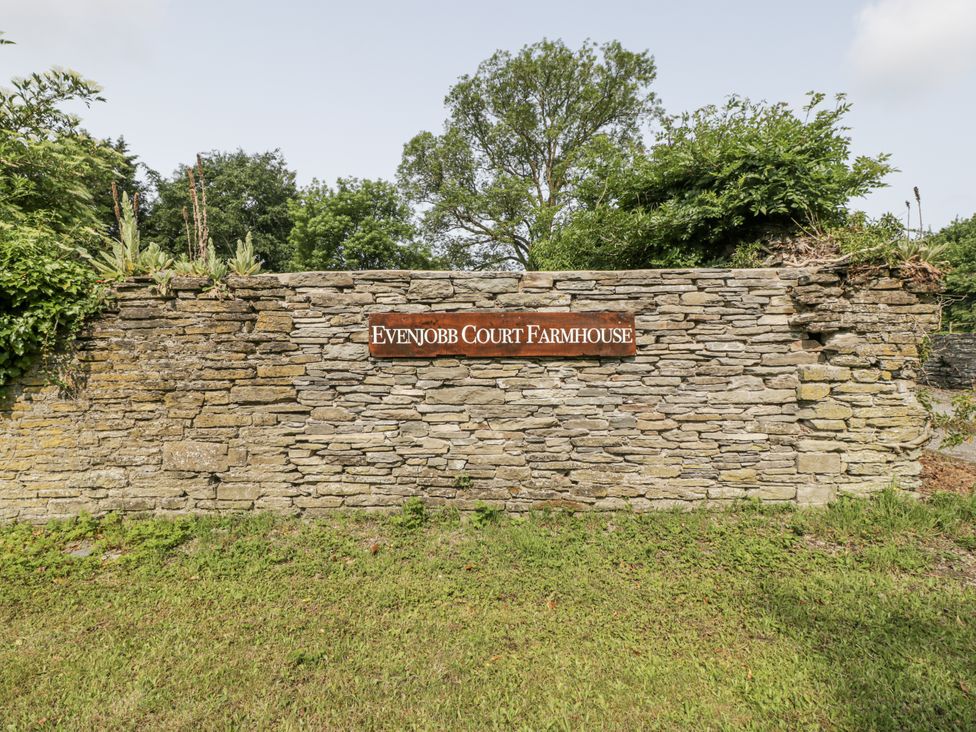 A stone wall with a sign at Evenjobb Court Farmhouse near Presteigne