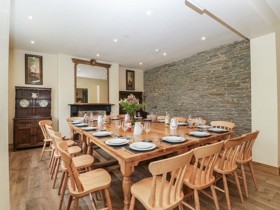 A dining room with a large table and chairs at Evenjobb Court Farmhouse in Evenjobb near Presteigne