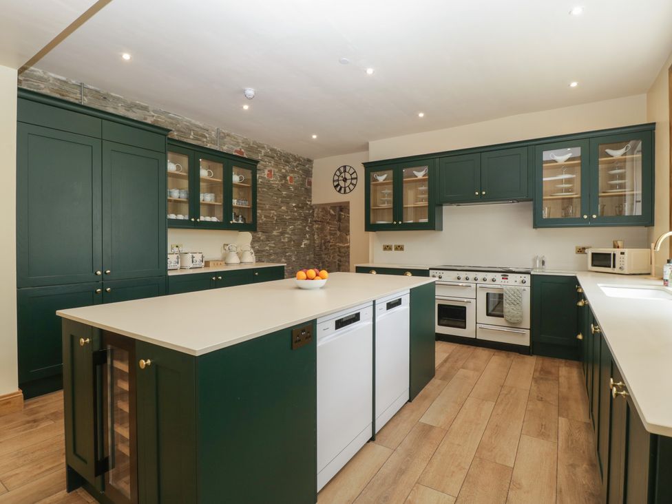 A kitchen with an island and appliances at Evenjobb Court Farmhouse Evenjobb near Presteigne