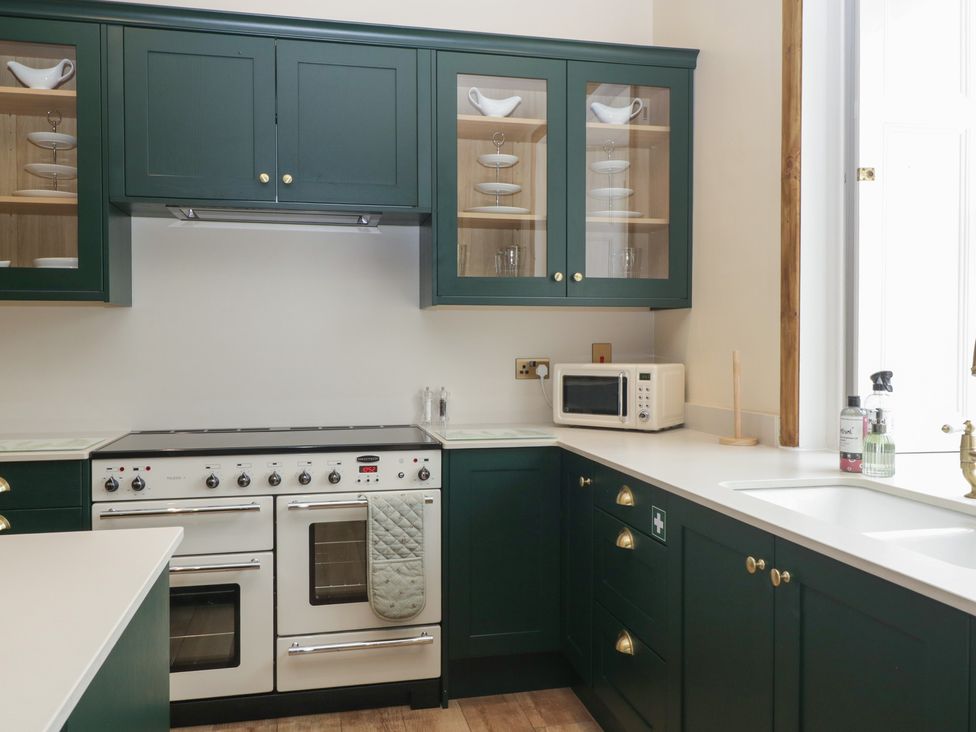 A kitchen with an oven and microwave at Evenjobb Court Farmhouse in Evenjobb near Presteigne