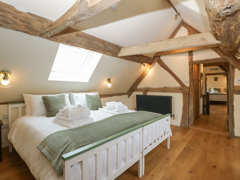 A bedroom with a bed and a radiator at Evenjobb Court Farmhouse Evenjobb near Presteigne