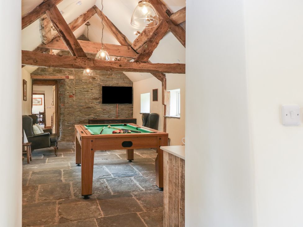 A game room with a pool table and a television at Evenjobb Court Farmhouse near Presteigne