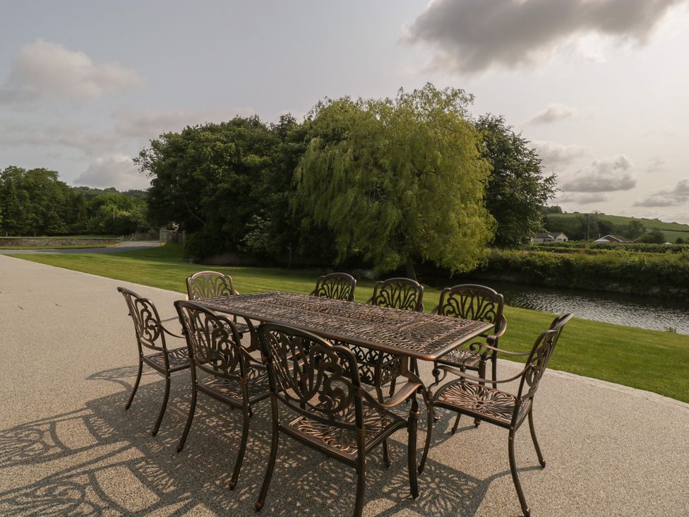 A patio with a table and chairs at Evenjobb Court Farmhouse near Presteigne