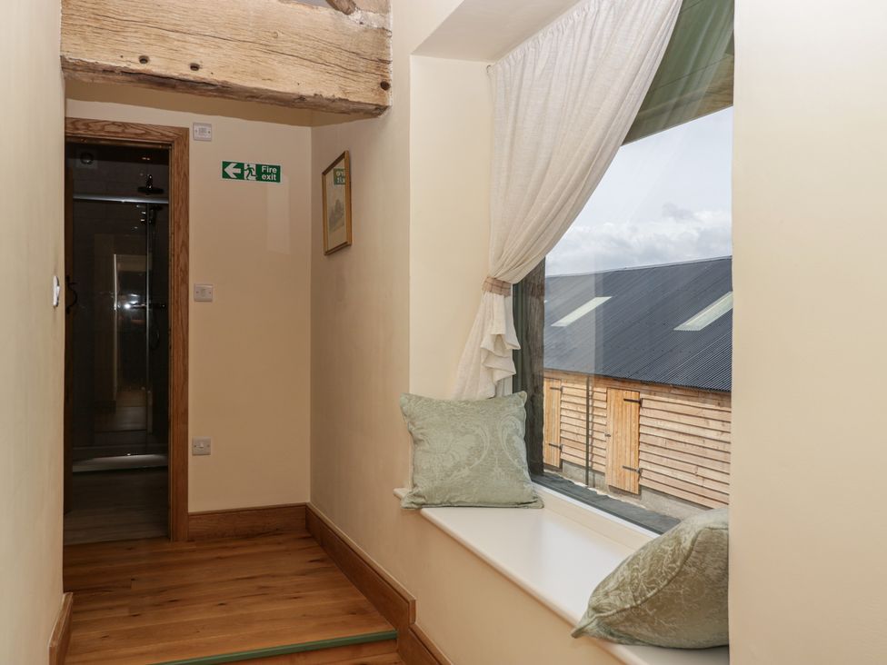 A hallway with a window and cushions at Evenjobb Court Farmhouse Evenjobb near Presteigne