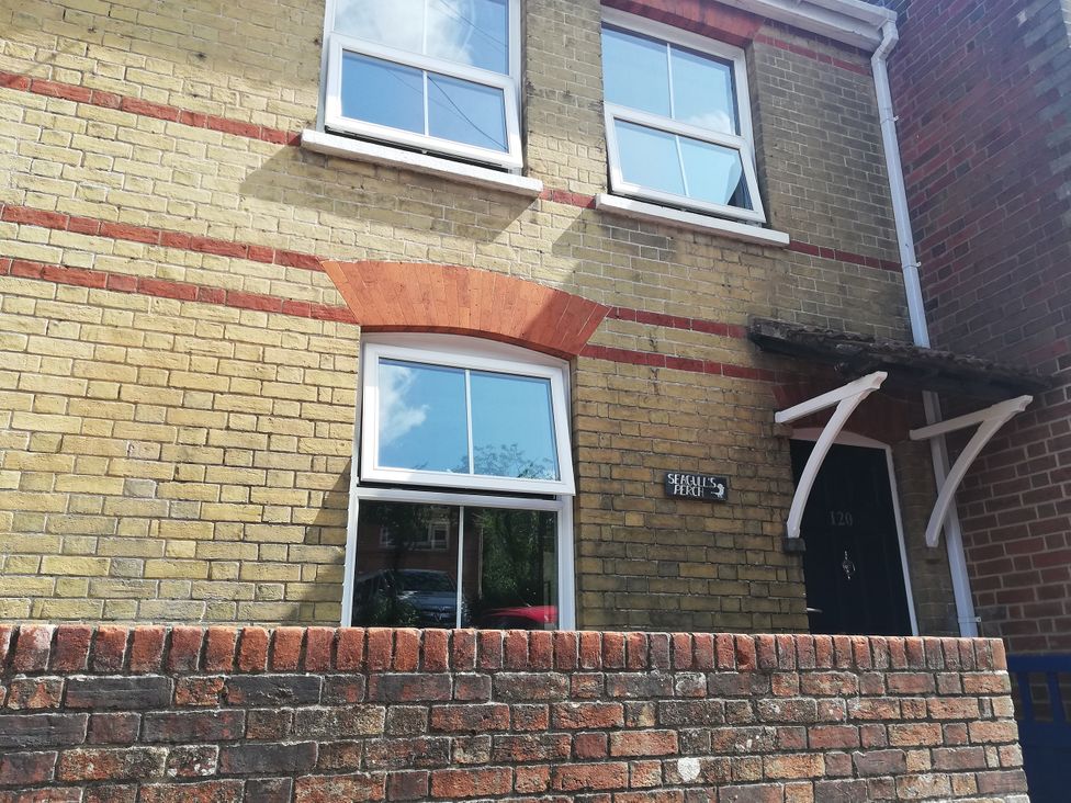 A brick house exterior with windows and a door at Seagull’s Perch in Cowes