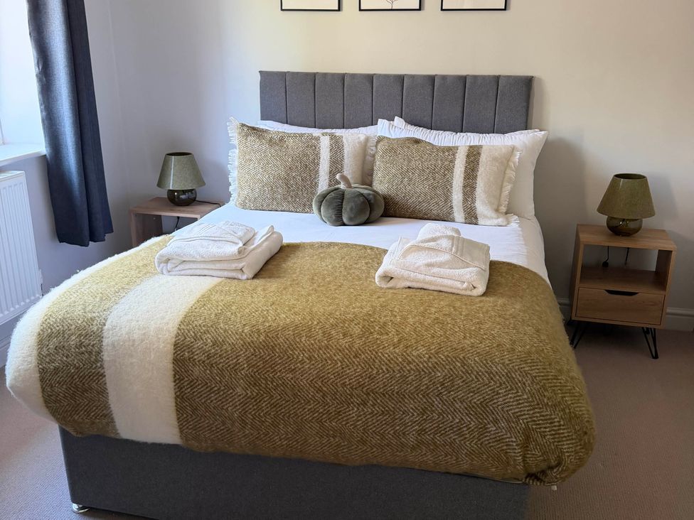 A bedroom with a bed and bedside table lamp at The Annexe Bridlington