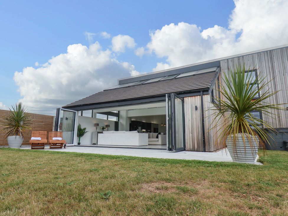 A house with glass doors leading to a living area at Mill Cottage in Walkington