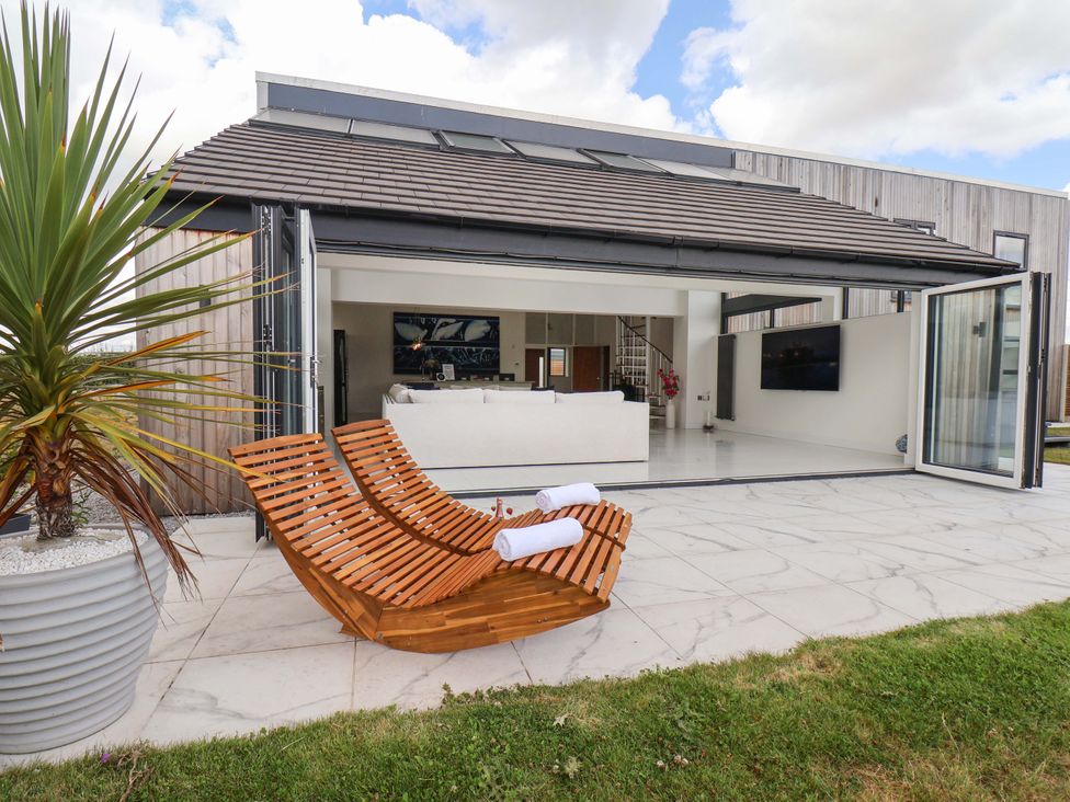 An outdoor seating area with a lounge chair at Mill Cottage in Walkington