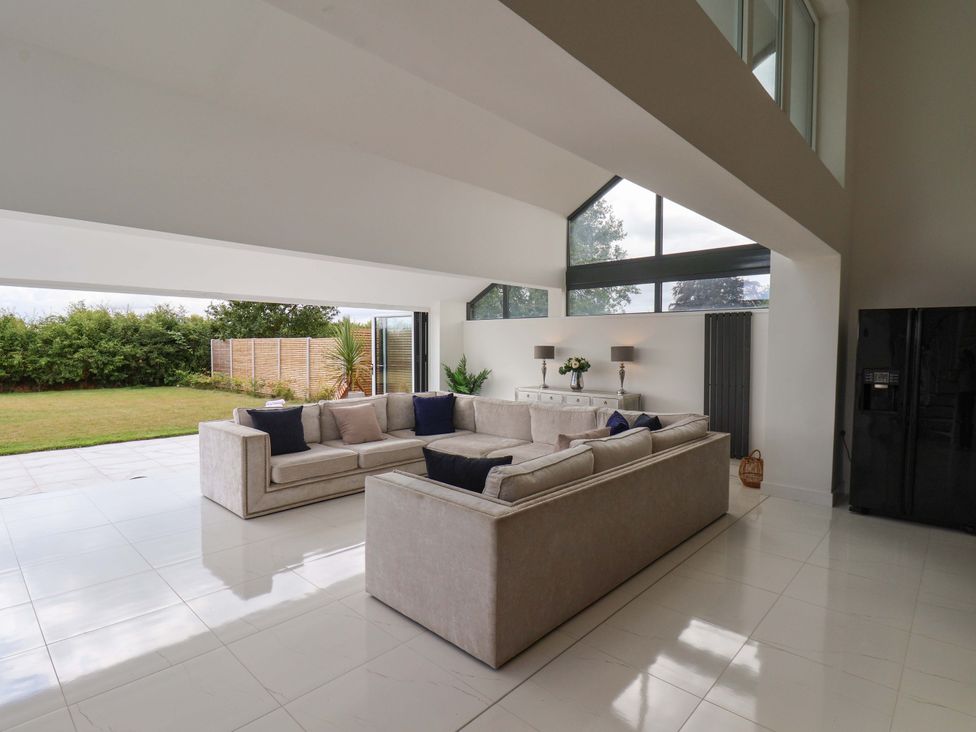 A living room with a sofa and a view of the garden at Mill Cottage in Walkington