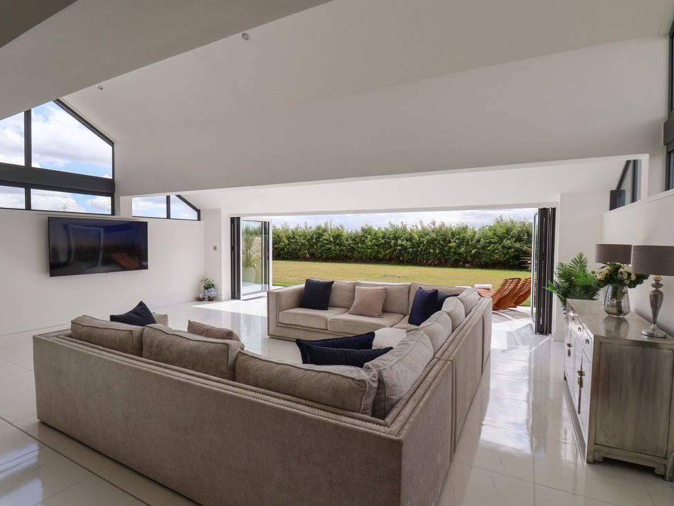 A living room with a sofa and television at Mill Cottage in Walkington
