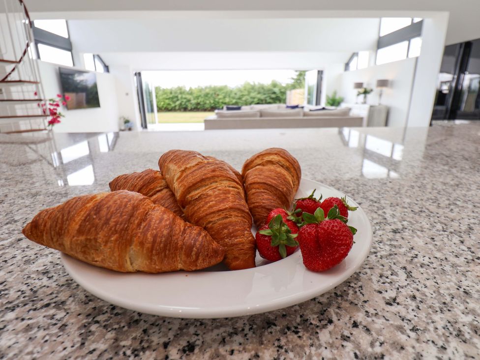 A plate with croissants and strawberries at Mill Cottage in Walkington
