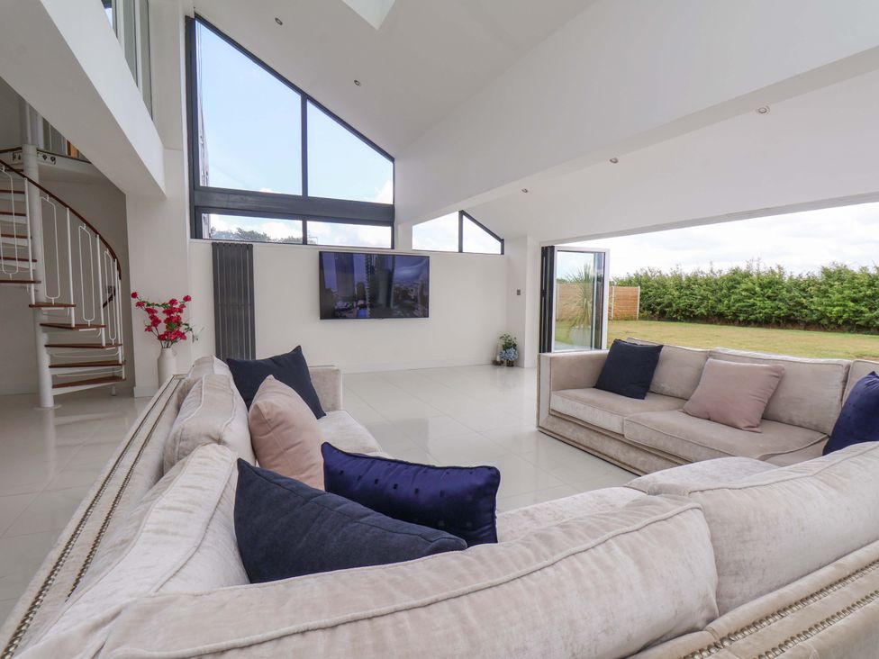 A living room with a sofa and television at Mill Cottage in Walkington