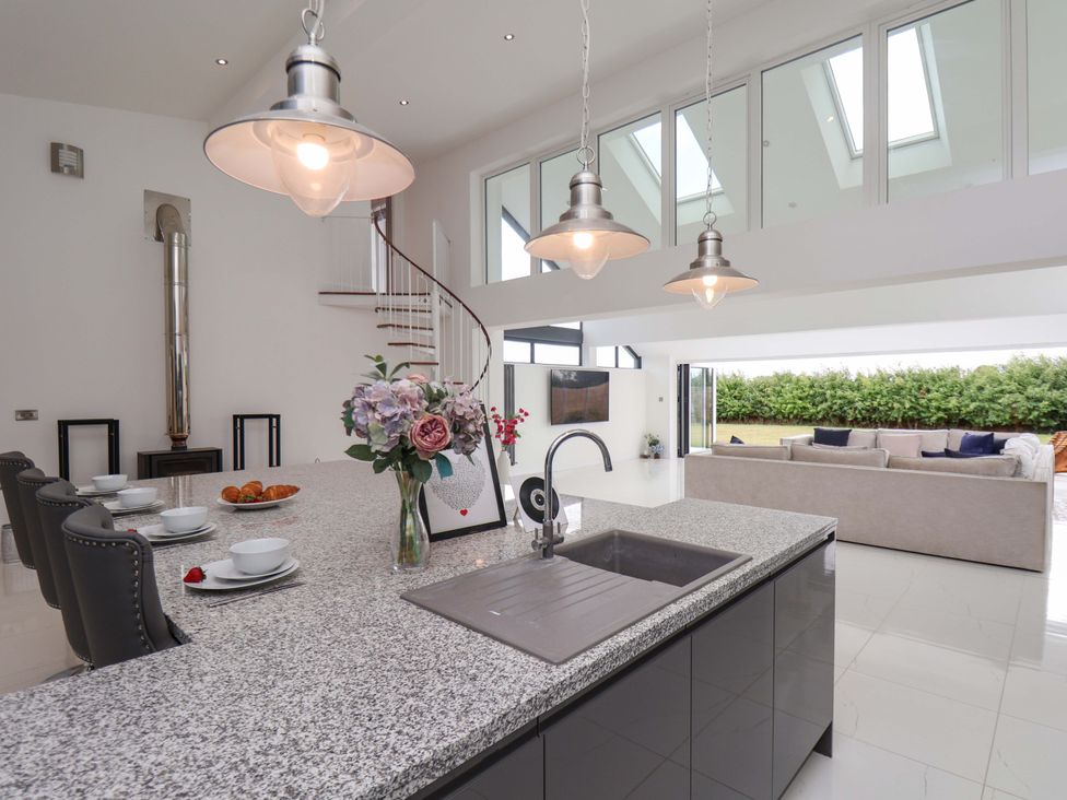 A kitchen with an island and sink at Mill Cottage in Walkington