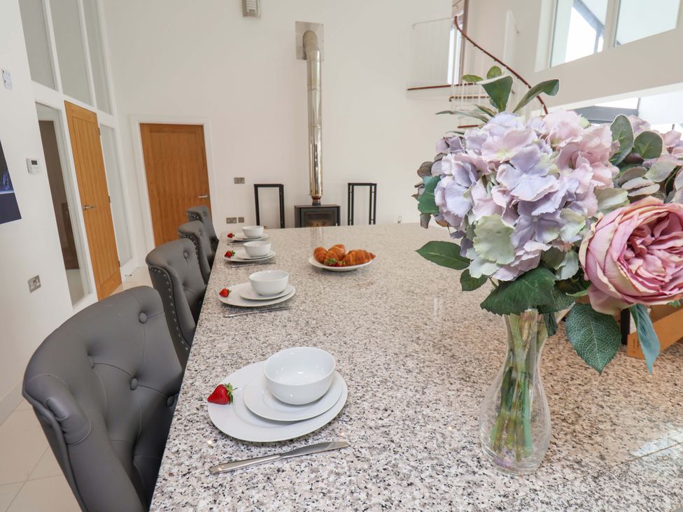 A dining room with a table set for meals at Mill Cottage in Walkington