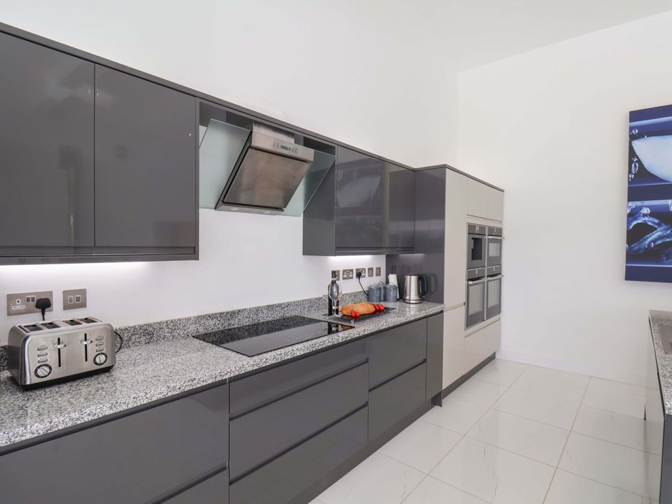 A kitchen with cabinets and appliances at Mill Cottage in Walkington