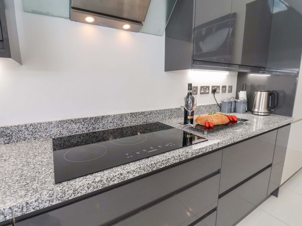 A kitchen with a granite countertop and induction cooktop at Mill Cottage in Walkington