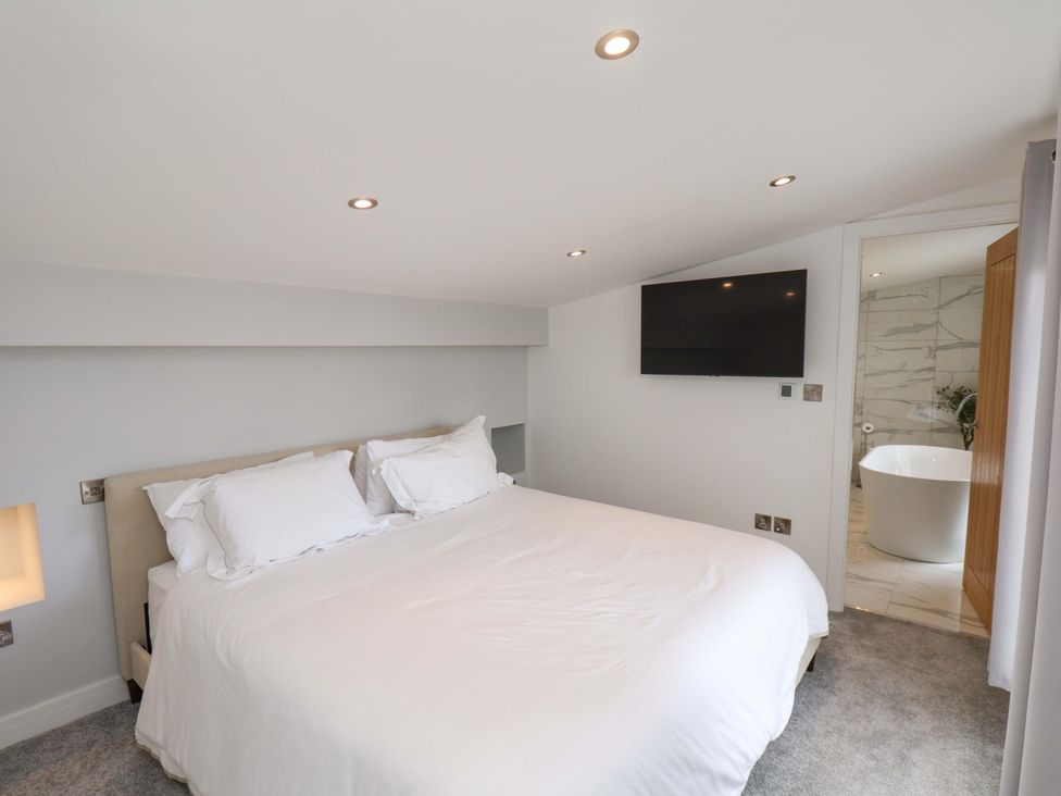 A bedroom with a bed and television at Mill Cottage in Walkington