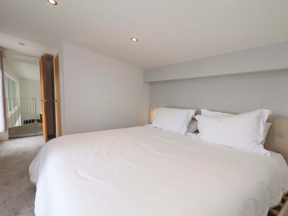 A bedroom with a bed and pillows at Mill Cottage in Walkington