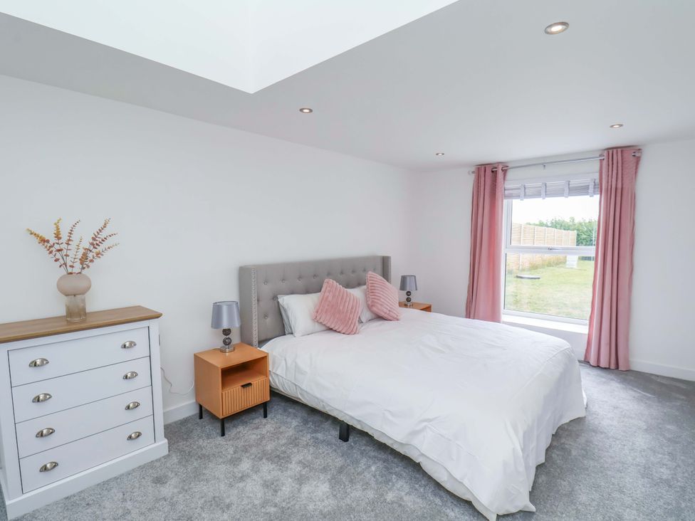 A bedroom with a bed and dresser at Mill Cottage in Walkington