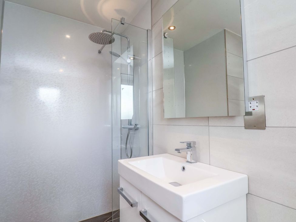 A bathroom with a shower and sink at Mill Cottage in Walkington