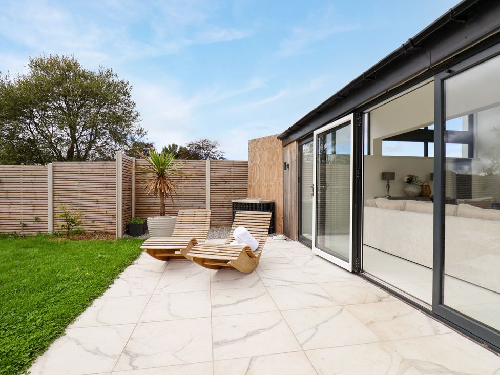 A patio area with deckchairs and glass doors at Meadow View Beverley near Walkington