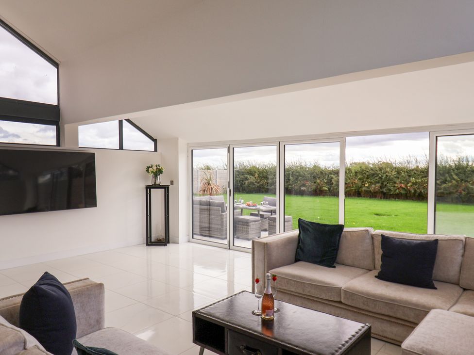 A living room with a television and seating area at Meadow View Beverley near Walkington