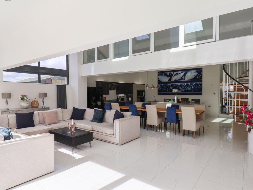A living room with a sofa and dining area at Meadow View in Beverley near Walkington