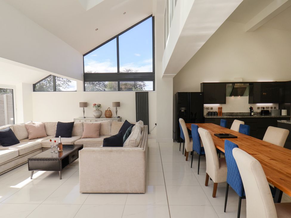 A living room with a sofa and dining area at Meadow View Beverley near Walkington