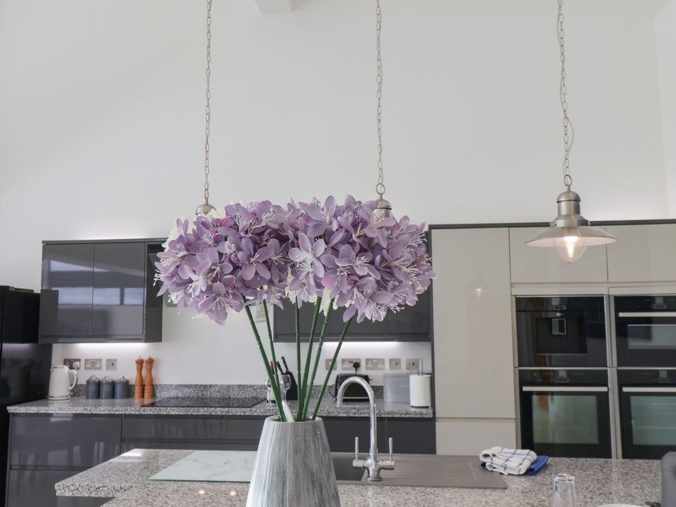 A kitchen with a flower vase on a countertop at Meadow View Beverley near Walkington