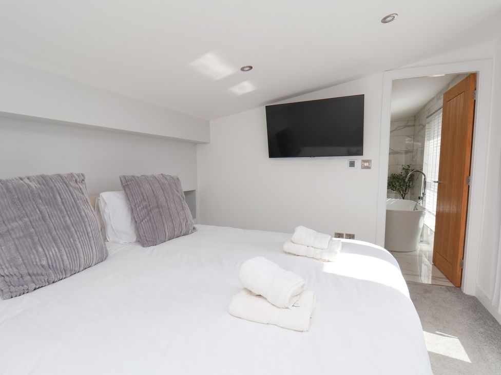 A bedroom with a bed and television at Meadow View Beverley near Walkington
